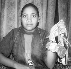 Twenty-one-year-old Manjit Kaur proudly displays the medals she won in various wrestling championships