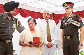 Martyr Major Amit Ahujas parents --- Mr Yashpal Ahuja and Ms Santosh Ahuja --- break down when the badge of sacrifice was presented