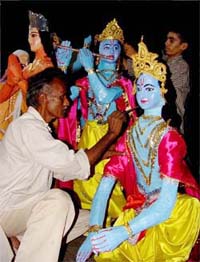 Dharampal from Faridkot gives finishing touches to an idol of Krishna for Janmashtami