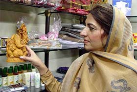 A woman member of the Pakistani parliamentarian delegation, Ms Ayaz Siddiqui, purchases an idol of Lord Ganesha from a department store in Amritsar