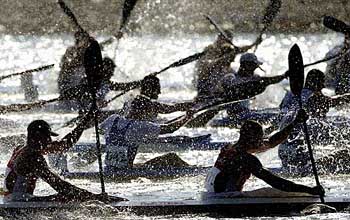 Kayakers leave the start line of the men's four 1000m semi final 