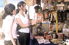 Girls shopping around at the Sawan Saras 2003 mela at Dilli Haat in the Capital on Sunday. 