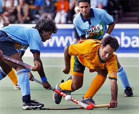 Australian captain Paul Gaudoin duels with his Indian counterpart Dhanraj Pillay 