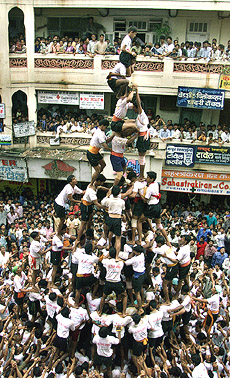 Men form a human pyramid to reach the matka as part of the Janmashthmi celebrations in Mumbai on Wednesday. 
