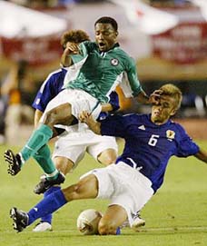 Japan's Junichi Inamato fights for the ball with Ike Kalu of Nigeria 