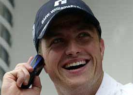 Williams driver Ralf Schumacher of Germany speaks on his mobile phone
