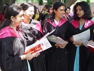 Students share a light moment after receiving their degrees at the Arya Girls College 