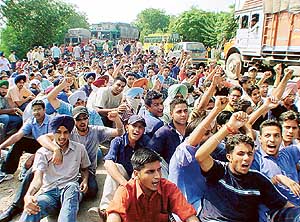 Students of the Institute of Engineering and Technology block the national highway to protest the recent decision of Punjab Technical University