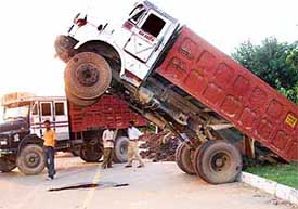 Up went the truck as the driver tried to download earth along the roadside in front of Durga Nursery