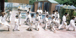 Children practising karate-do under the supervision of chief instructor Naval
