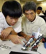 Yuki Miyazawa programmes a two-legged walking robot