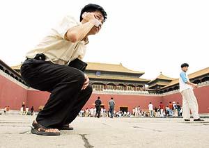 A man talks on his mobile phone in Beijings Forbidden City