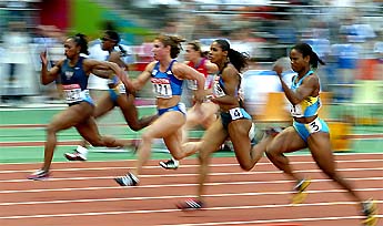 Gail Devers of the US and compatriot Ekaterni Thanou run during the semifinal of the women's 100m at the 9th World Athletics championships