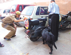 Delhi Police personnel checking vehicles in the Shastri Bhavan parking area
