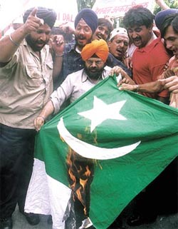 Activists of the National Akali Dal burn the flag of Pakistan in protest against the ISIs alleged involvement in the Mumbai bomb blasts at Jantar Mantar