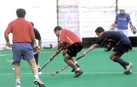 FCI Headquarter and Indian Airlines vie for the ball in a Delhi Hockey League match at the Shivaji stadium