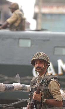 A Border Security Force jawan takes up position after militants made a suicide attack on the Central Telegraph Office in Srinagar on Wednesday.