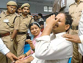 Two relatives of a stampede victim cry in a Nashik hospital on Wednesday, 187 km north of Mumbai. 