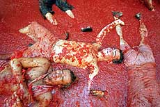 Revellers lie in tomato pulp during the annual "Tomatina" battle in Bunyol