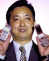 Chinese company Bird International Managing Director K P Wong shows cell phone models produced by his company 