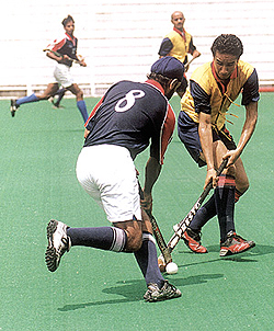 A mid-field tussle for the ball in the first semi-final of the Delhi Hockey League between Northern Railway and FCI Headquarters at the Shivaji Stadium on Thursday.