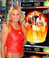 Anna Kournikova poses in front of the Microsoft XSN Sports logo