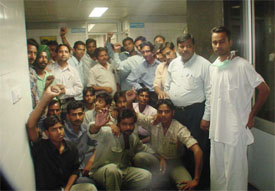 Members of the DMC employees union raise slogans against the management outside the office of the Director