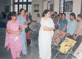 Ms Varinder Thind, Principal, Khalsa College for Women, and other staff members take a round of a collage exhibition on the college campus
