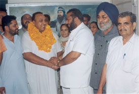 Mr Manjit Singh Bawa, newly appointed president of the US unit of the Bairagi Mahamandal, is congratulated by Mr K.K.Bawa, mandal chief