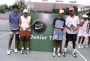 Poojashree and Shweta Chandra, Kaushik Das and Kinshuk Sharma who won the girls and boys doubles titles in the Junior Tour Tennis Tournament at the DLTA courts