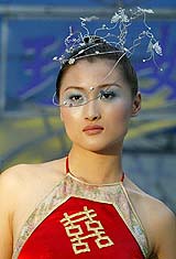 A model displays a wedding dress at a promotional event in Shanghai 