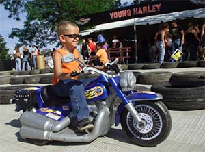 A youngster rides a battery-powered toy motorcycle at the Harley-Davidson Experience in downtown Milwaukee