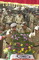 A BSF officer places a wreath on the coffin of Balbir Singh in Srinagar 