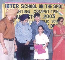 A student receiving an award in the painting competition organised by GHPS, Vasant Vihar