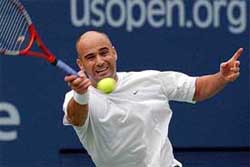 Andre Agassi of the US returns to Yevgeny Kafelnikov of Russia