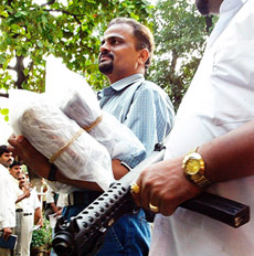 A policeman carries explosives in Mumbai 