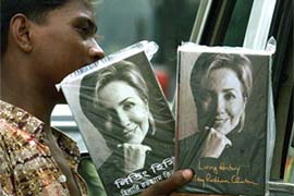 A hawker sells the English and Bengali versions of Living History, a book by Hillary Rodham Clinton