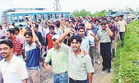 Students of various engineering colleges, Punjab, block the traffic in support of their demands at the state highway near Balongi on Wednesday.