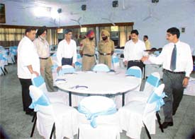 Officials make final seating arrangements at the table where the President will have lunch at Sukhdev Bhavan