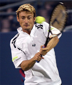 Juan Carlos Ferrero of Spain hits a return to Todd Martin of the US