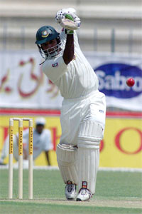 Bangladeshi batsman Habibul Bashar drives Pakistani fast bowler Umar Gul
