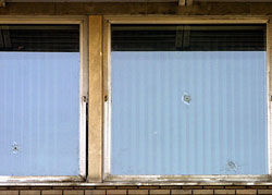 Bullet holes can be seen on window panes of the British Embassy in Tehran