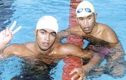 Deepak Kumar Singh of CRPF, who won a gold in the 200m breast stroke with a new meet record, and silver medallist M Premanand strike a pose after their wins in the Police Aquatic Championship in the Capital on Thursday.