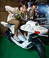 Paramount Home Entertainment Japan promoter Akiko Yamada mounts the Star Trek original Enterprise bike