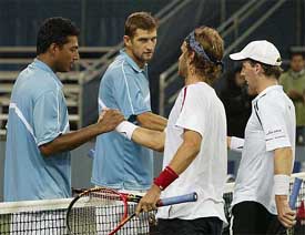 Mahesh Bhupathi and Max Mirnyi shake hands after defeating Lucas Arnold and Mariano Hood in the third round of the US Open Tennis Tournament