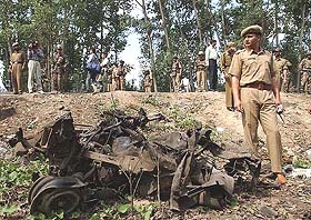 Policemen inspect the wreckage of a car which the police say was used for the explosion in Srinagar 