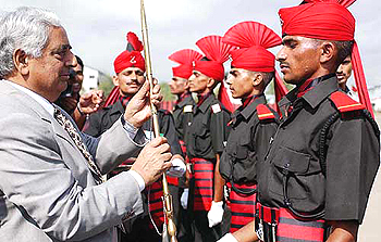 Jammu and Kashmir Chief Minister Mufti  Mohammad Sayeed  presents the Sher-e-Kashmir, Sheikh Abdullah sword of honour to  recruit Hardeep Singh 