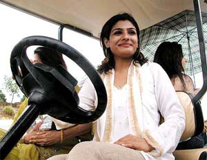 Bollywood actress Ravina Tandon enjoys a ride during the flagging off ceremony of the Daksh Prayas Golf tournament 