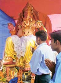 Devotees pay obeisance to the 20-foot-high idol of Lord Ganesha during Ganpati mahotsava