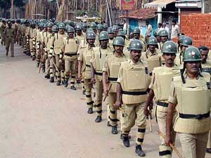 Police personnel flag march on the streets to maintain law and order during Ganapati immersion in Hubli
